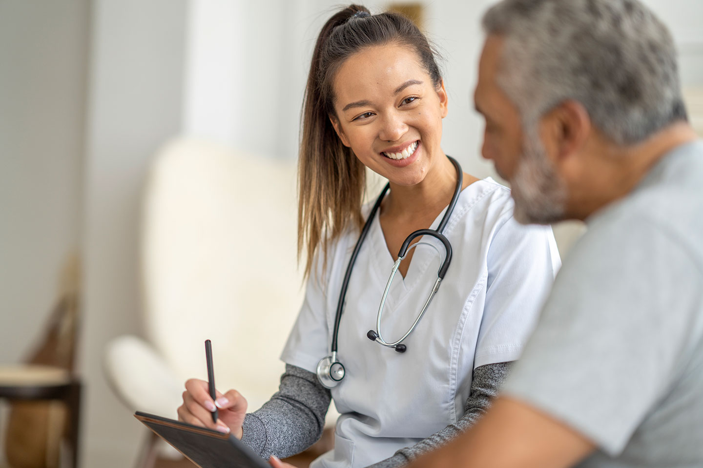 Female physician talking to older male patient